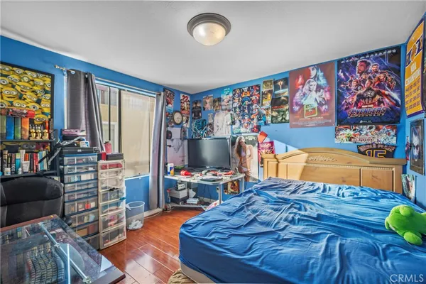 a bed room with furniture and a flat screen tv