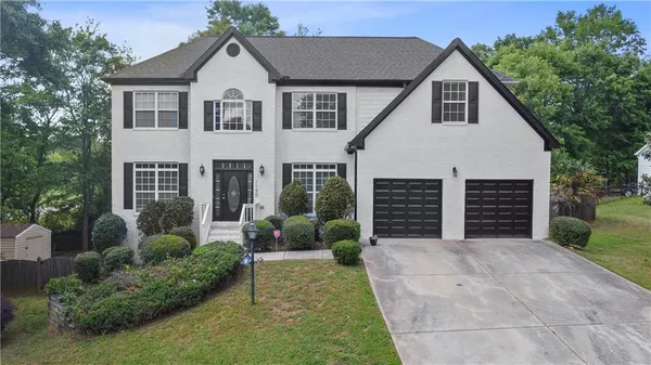 a view of a house with a yard and plants