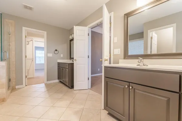 a bathroom with a sink vanity and a mirror