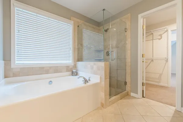 a bathroom with a bathtub and a shower