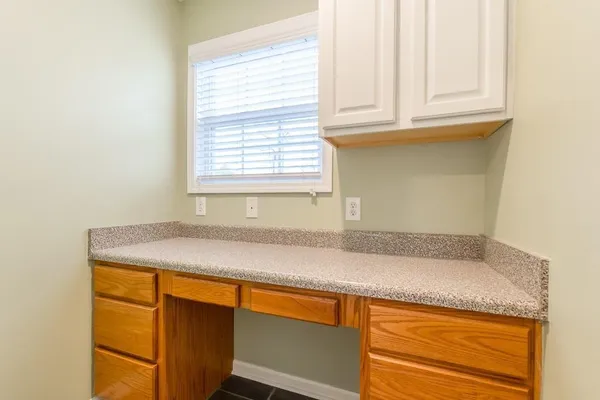 a utility room with granite countertop cabinets washer and dryer