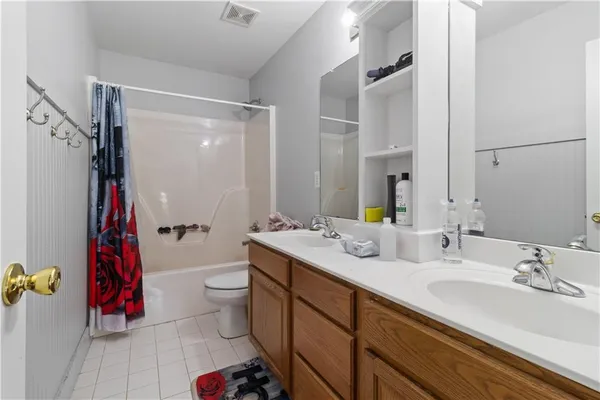 a bathroom with a sink vanity mirror and toilet