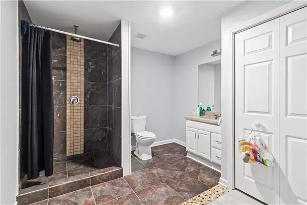 a bathroom with a toilet and a shower