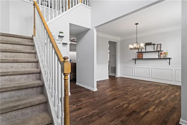 a view of a kitchen with wooden floor and staircase