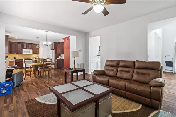 a living room with furniture kitchen view and a table