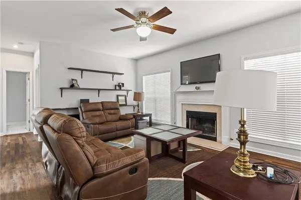 a living room with furniture a fireplace and a flat screen tv