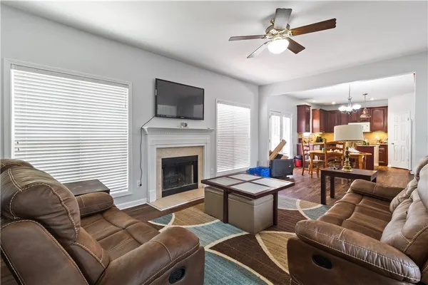 a living room with furniture a fireplace and a flat screen tv