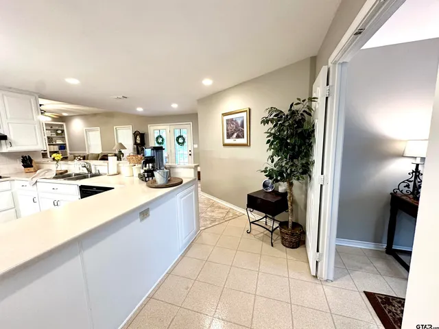 a kitchen with a sink appliances and cabinets