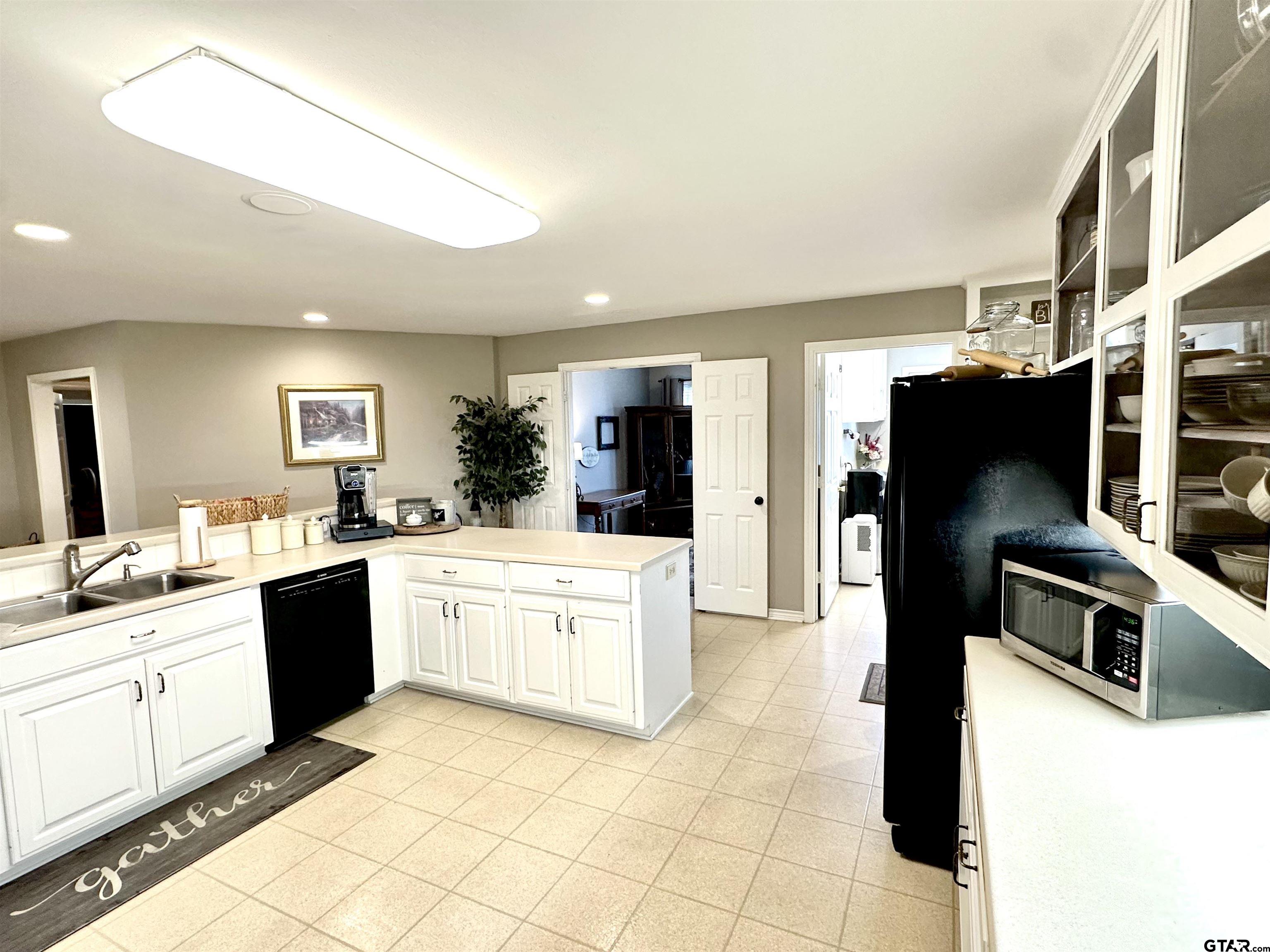 142 Parrish Rusk, TX 75785 - Photo 16 of 48 a kitchen with stainless steel appliances kitchen island granite countertop a refrigerator and a stove top oven