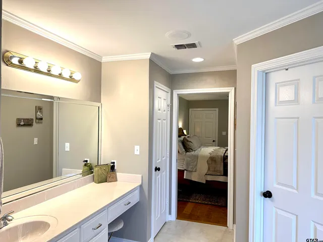 a en suite bathroom with a sink shower and a mirror