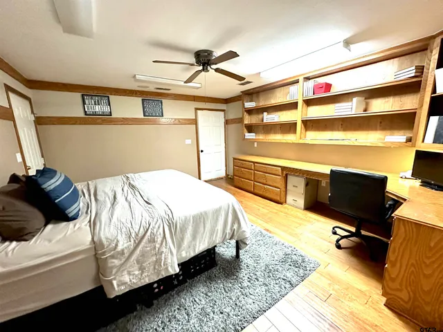 a bedroom with a bed and wooden floor