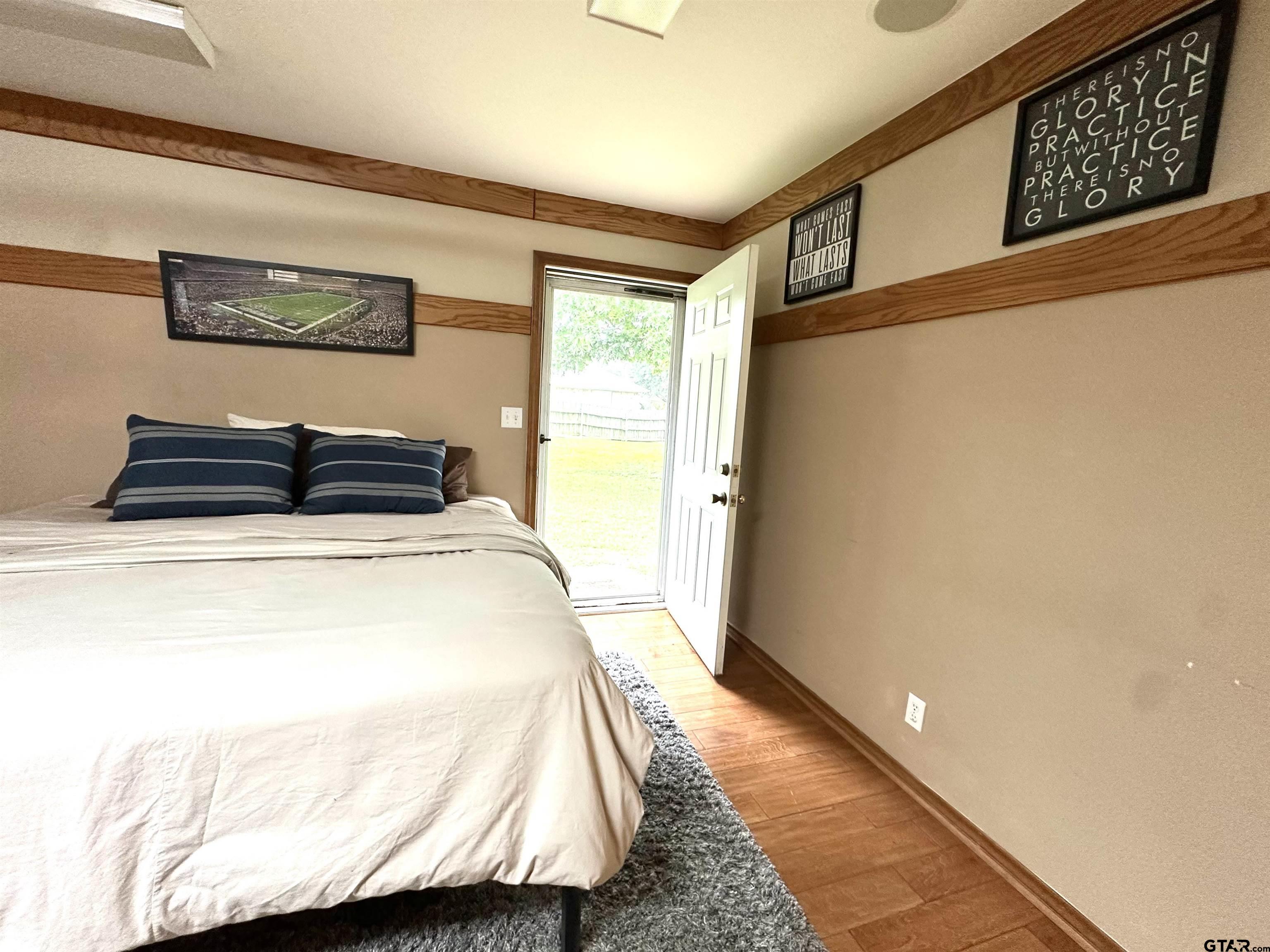 142 Parrish Rusk, TX 75785 - Photo 32 of 48 a bedroom with a bed and wooden floor