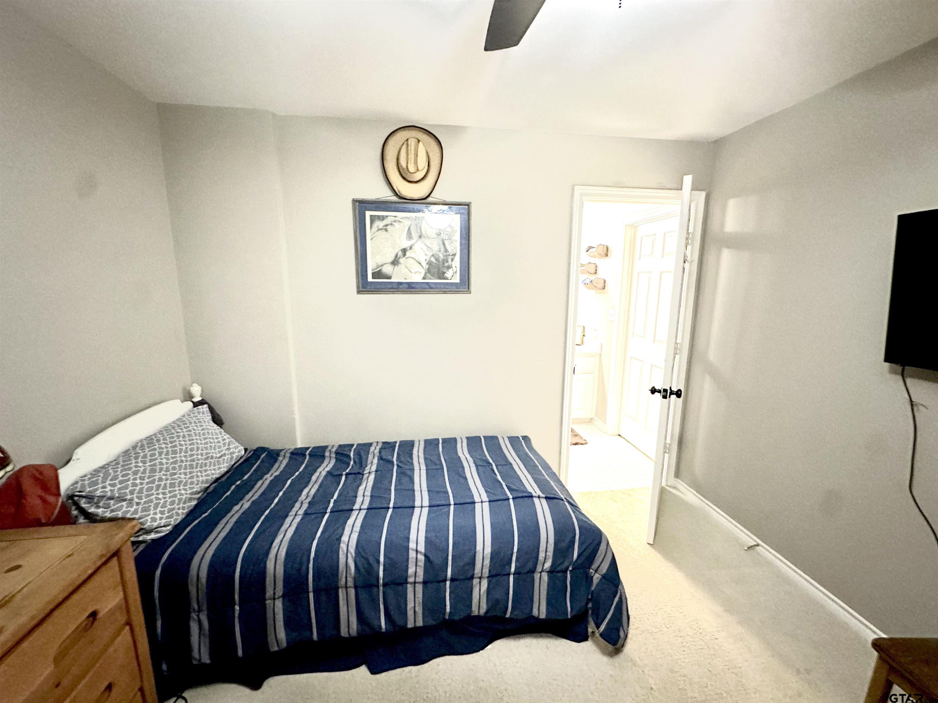 142 Parrish Rusk, TX 75785 - Photo 35 of 48 a bedroom with a bed and painting on the wall