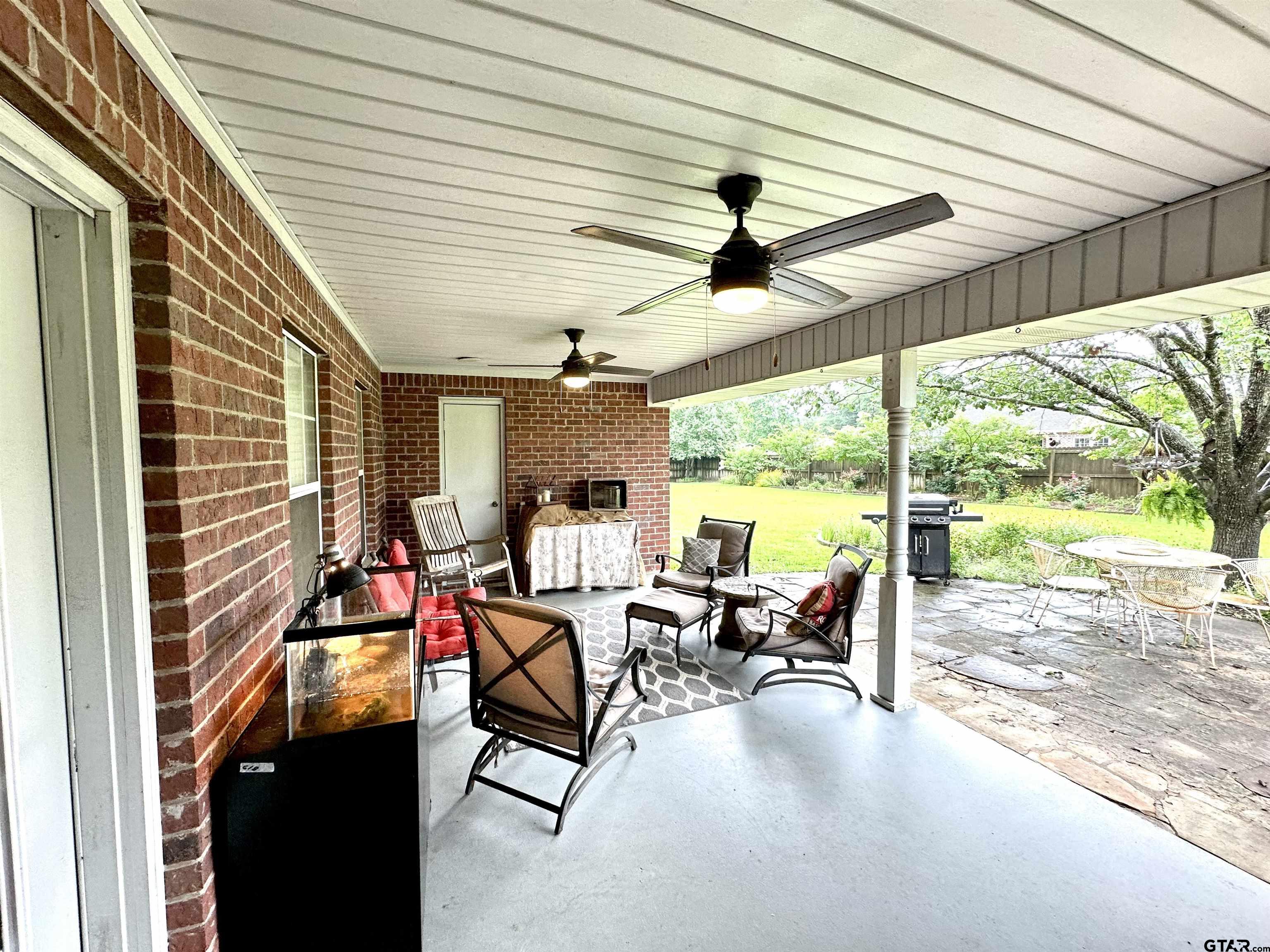 142 Parrish Rusk, TX 75785 - Photo 42 of 48 a view of a patio with table and chairs and floor to ceiling window with wooden floor