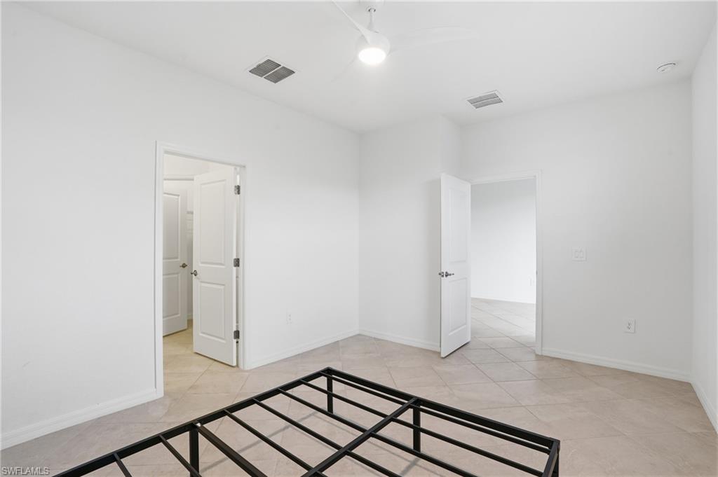 2215 Dragonfruit Way Naples, FL 34120 - Photo 23 of 38 a view of a livingroom with wooden floor and white walls