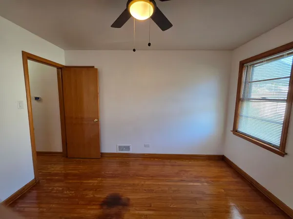 a view of an empty room and wooden floor