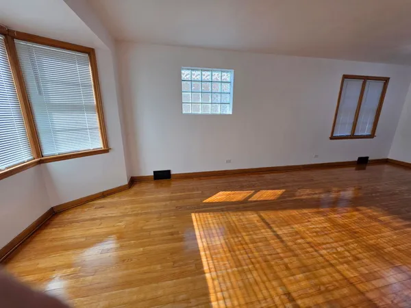 a view of room with window and wooden floor