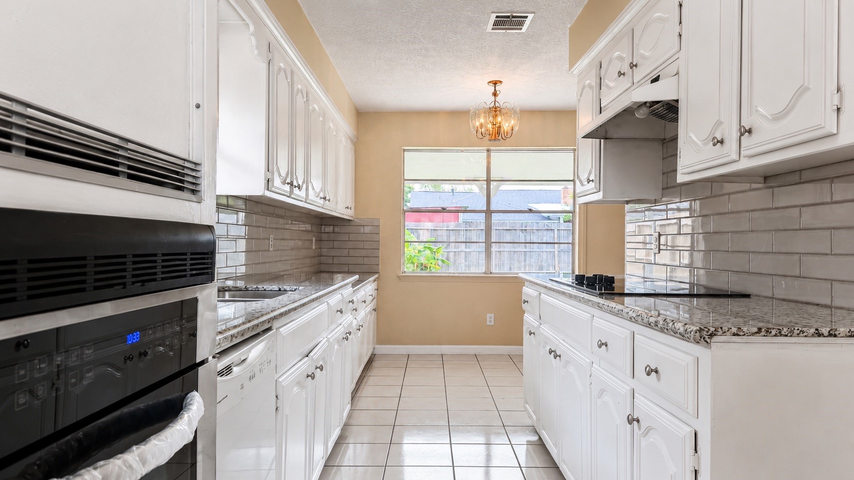 4418 Ponca Street Pasadena, TX 77504 - Photo 7 of 23 Close kitchen view with useful cabinet storage and updated surfaces. (image has been enhance for marketing purposes)