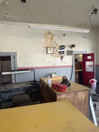 a kitchen with cabinets a sink and chairs