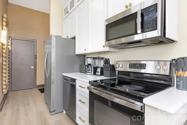a kitchen with stainless steel appliances granite countertop a stove and a microwave