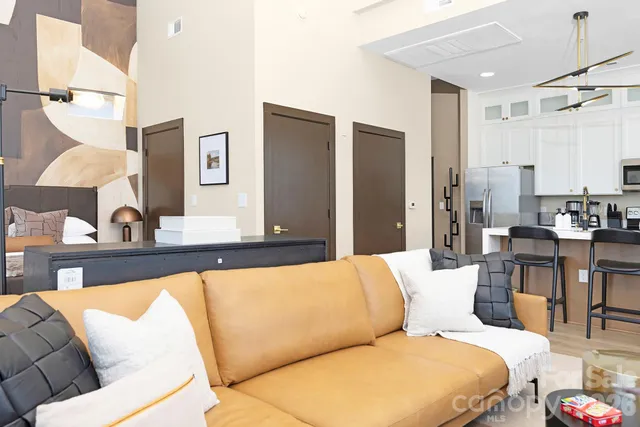 a living room with furniture and a large mirror