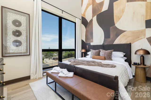 a bedroom with a bed and large window