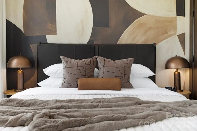 a bedroom with a bed and a lamp