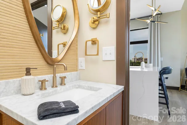 a bathroom with a granite countertop sink and a mirror