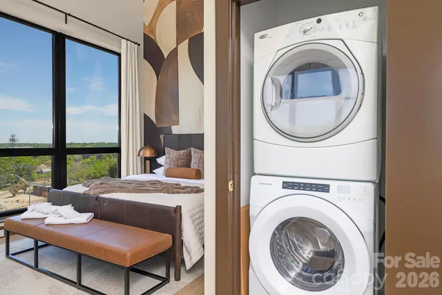 a bedroom with furniture and a large window