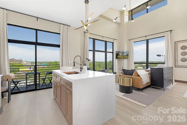 a view of living room with furniture and large windows