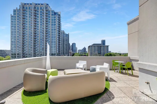 a view of a roof deck with couches and potted plants