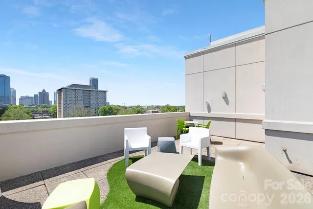 a balcony with table and chairs