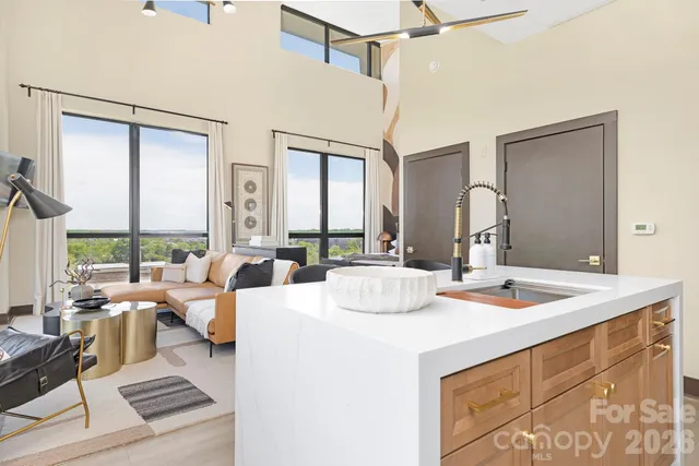 a living room with large window and furniture