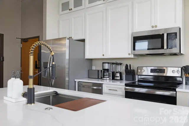 a kitchen with stainless steel appliances and white cabinets