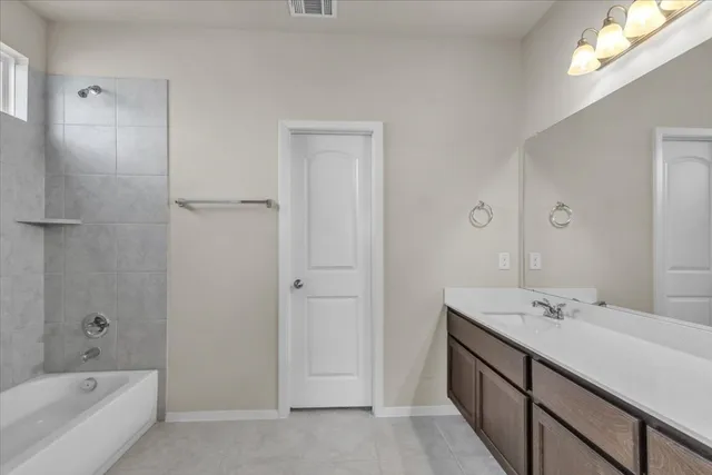 a bathroom with a tub sink and mirror
