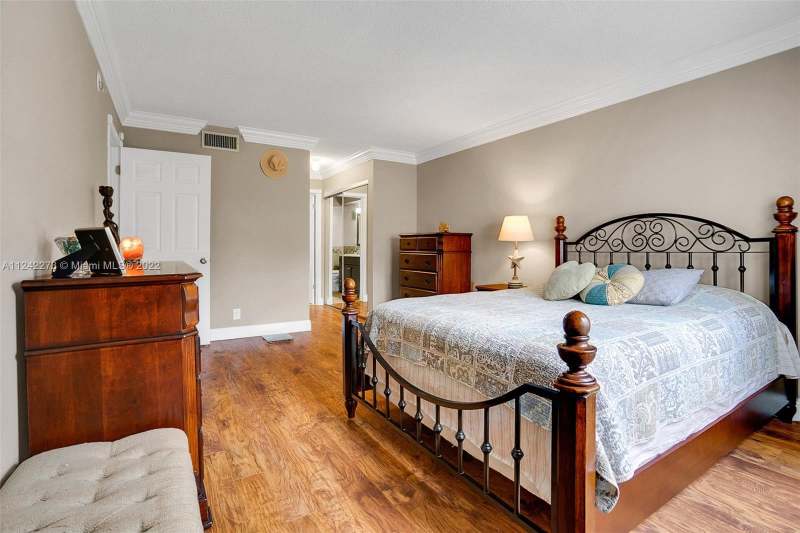 303 Racquet Club Road, Unit 307 Weston, FL 33326 - Photo 12 of 22 a bedroom with a bed and a refrigerator