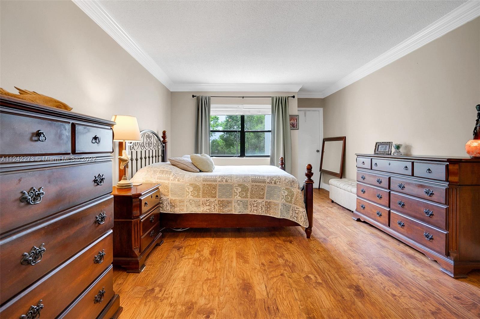 303 Racquet Club Road, Unit 307 Weston, FL 33326 - Photo 13 of 22 a bedroom with a bed and a dresser