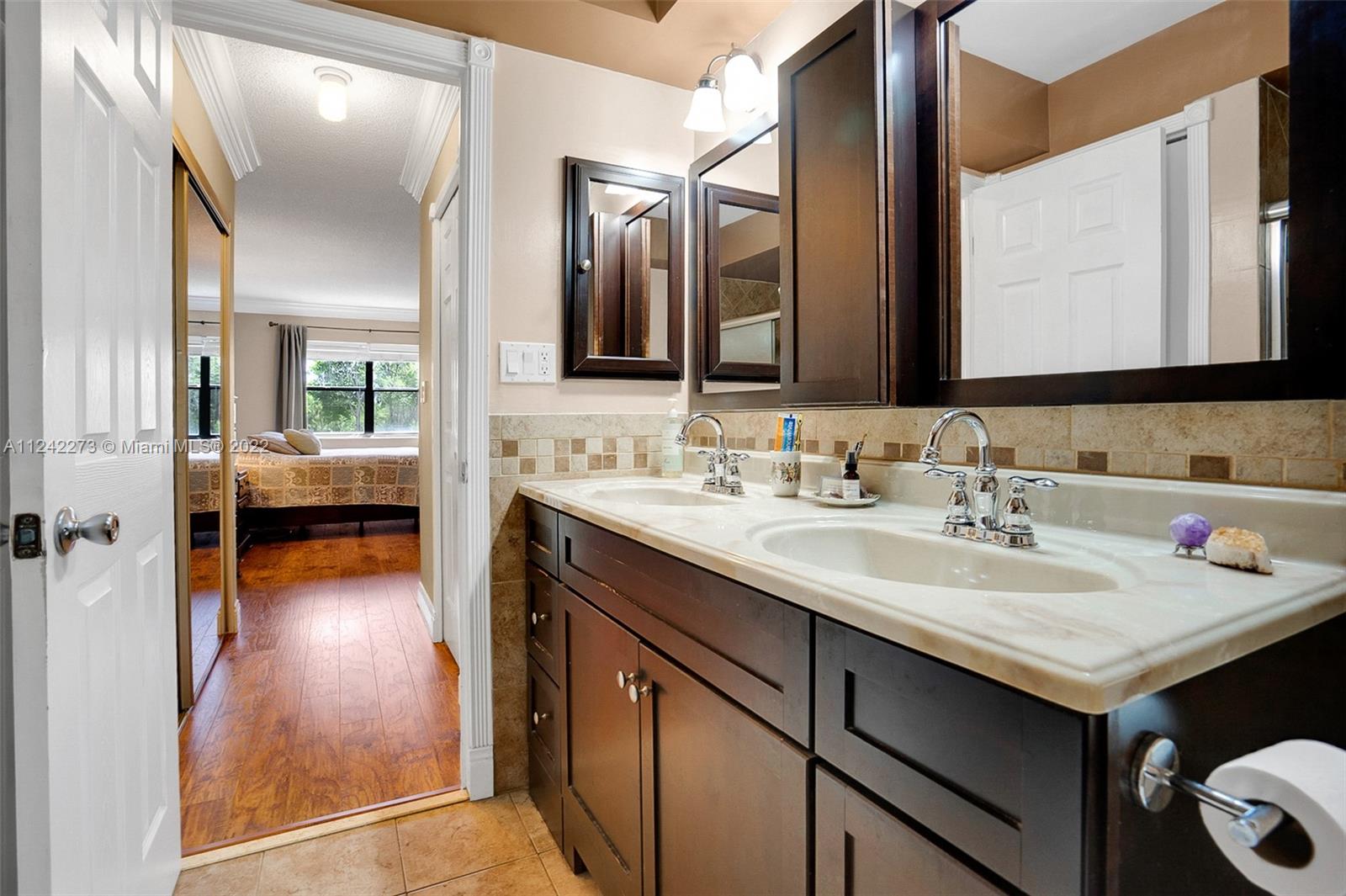 303 Racquet Club Road, Unit 307 Weston, FL 33326 - Photo 15 of 22 a en suite bathroom with a sink and a mirror