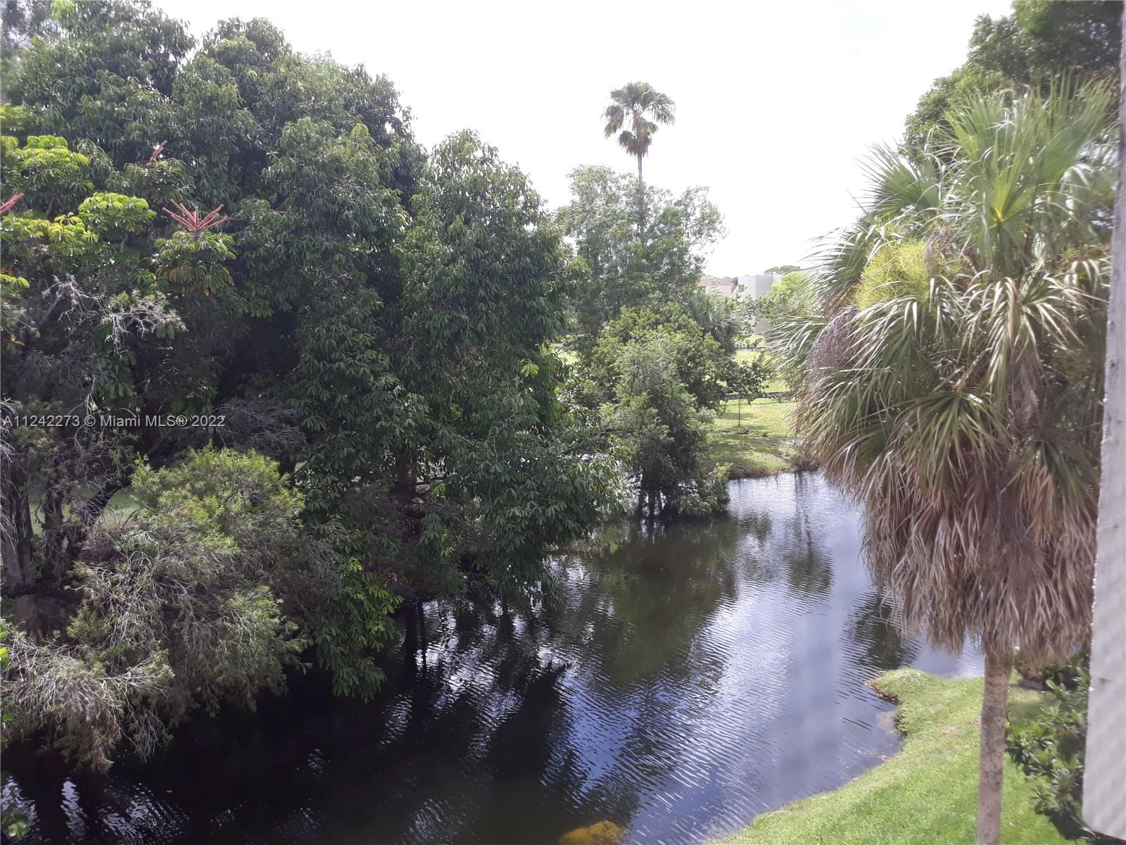 303 Racquet Club Road, Unit 307 Weston, FL 33326 - Photo 2 of 22 a view of a lake with outside space