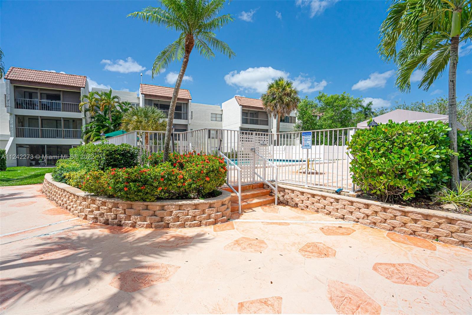 303 Racquet Club Road, Unit 307 Weston, FL 33326 - Photo 21 of 22 a view of a garden with a patio