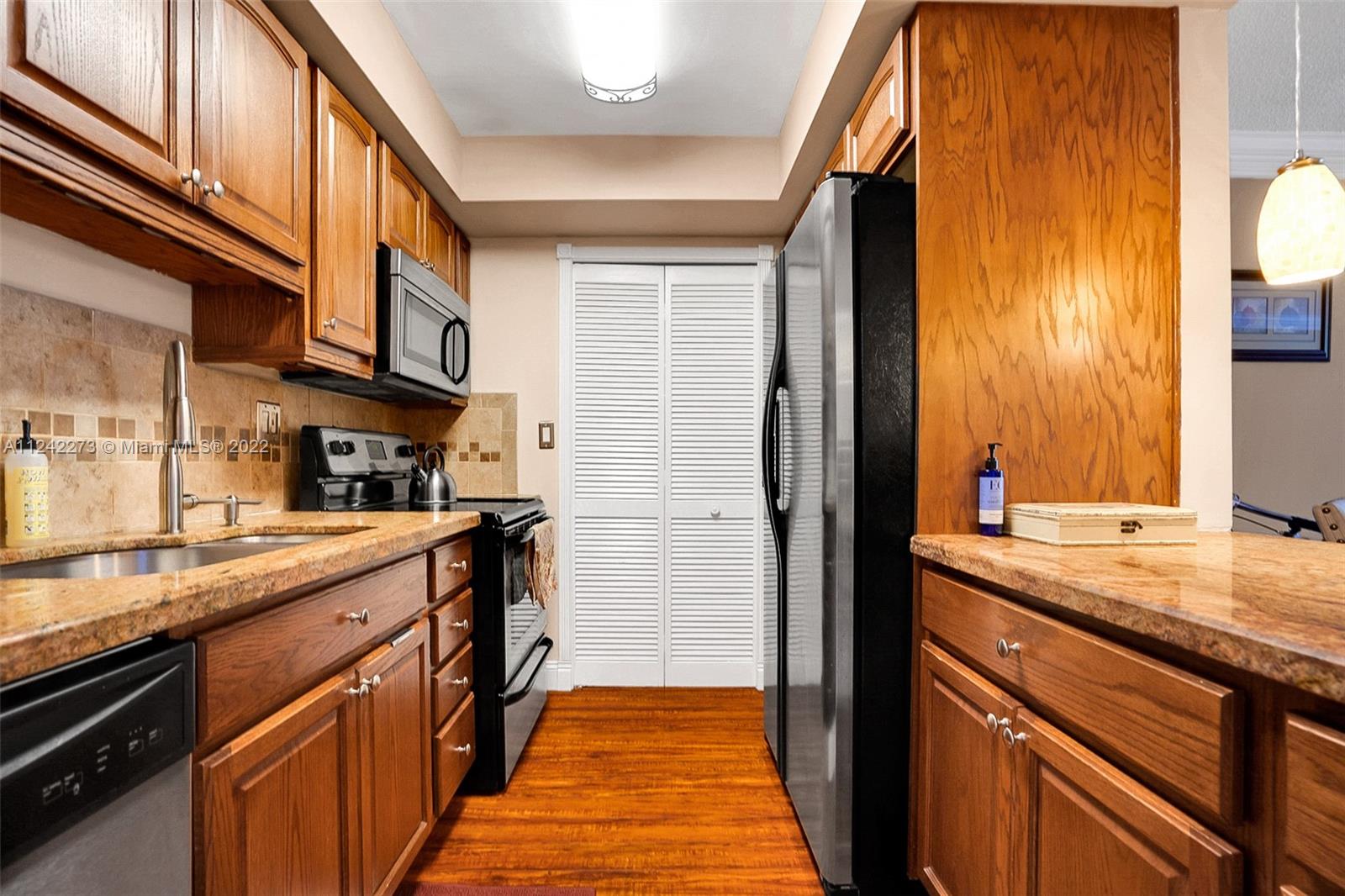 303 Racquet Club Road, Unit 307 Weston, FL 33326 - Photo 4 of 22 a kitchen with stainless steel appliances granite countertop a sink and cabinets