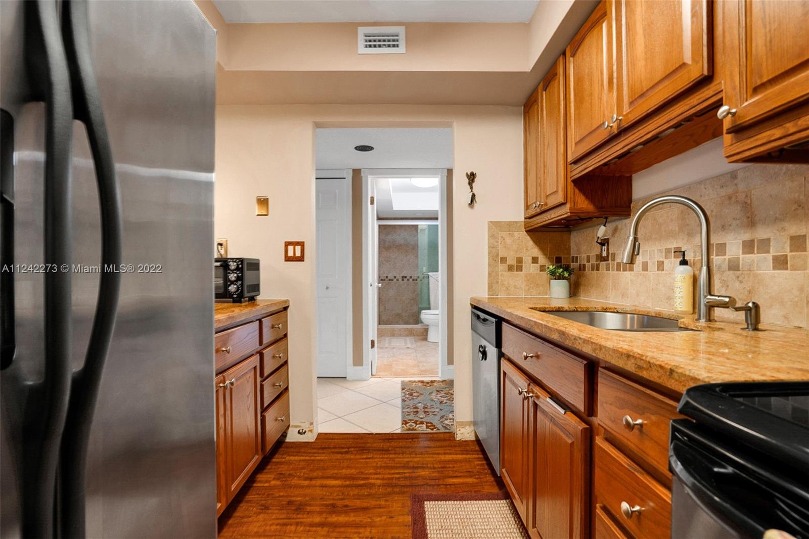 303 Racquet Club Road, Unit 307 Weston, FL 33326 - Photo 7 of 22 a kitchen with stainless steel appliances a sink and cabinets