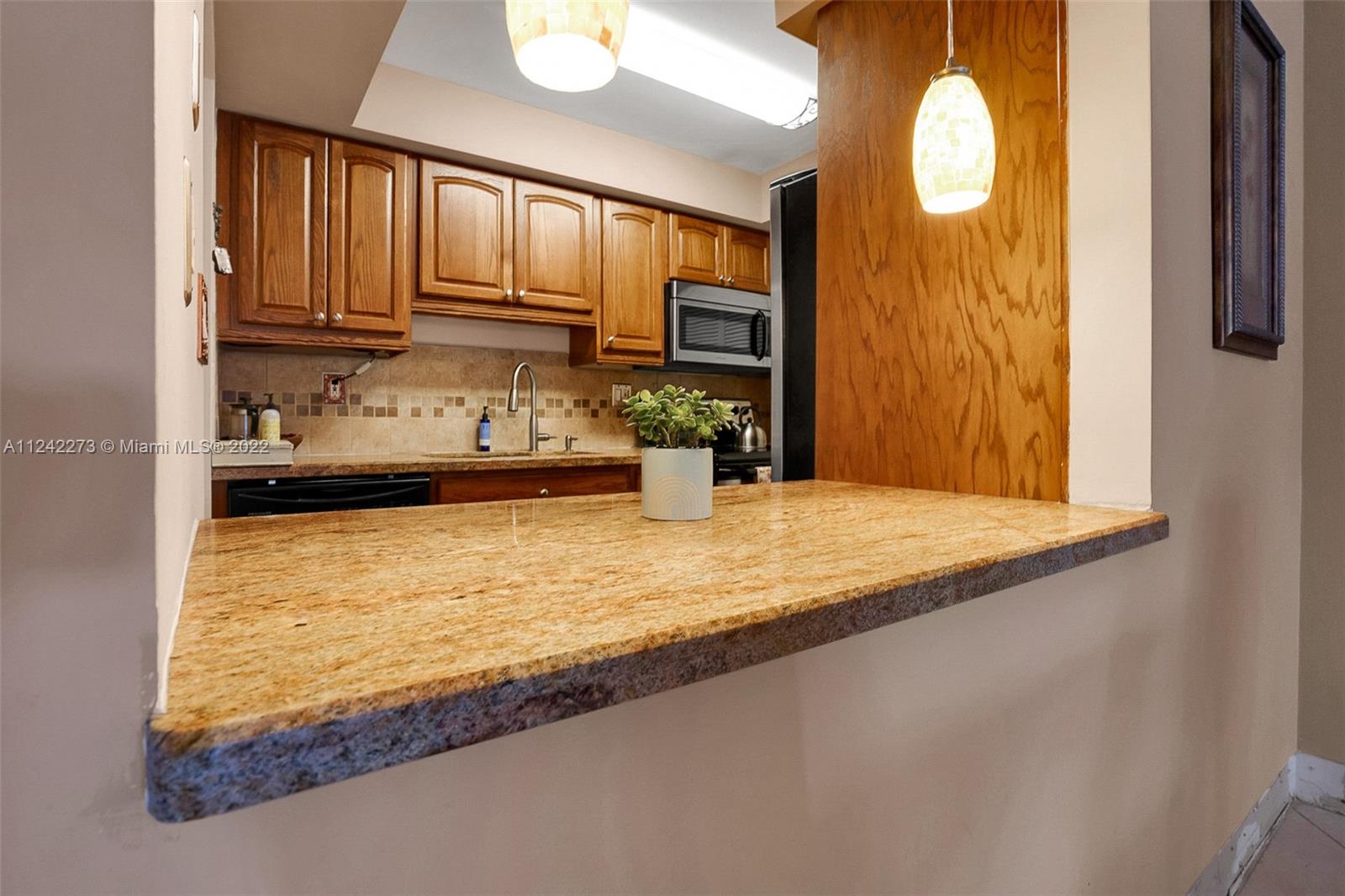 303 Racquet Club Road, Unit 307 Weston, FL 33326 - Photo 8 of 22 view of kitchen with wooden floor