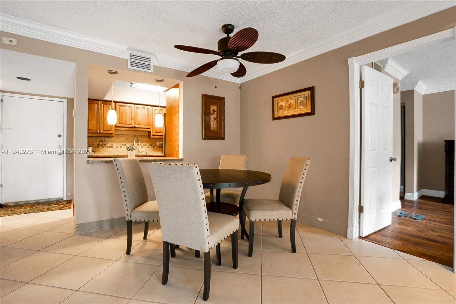 303 Racquet Club Road, Unit 307 Weston, FL 33326 - Photo 9 of 22 a view of a dining room with furniture and a chandelier