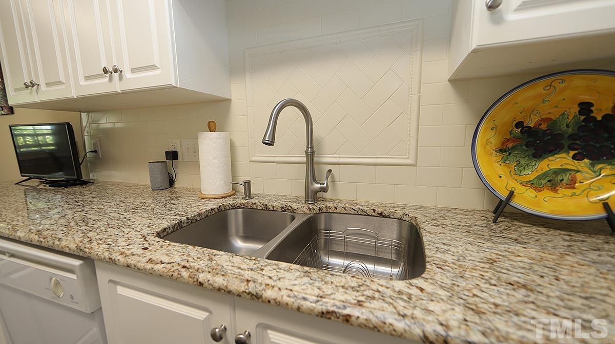 100 Northbrook Drive, Unit 203 Raleigh, NC 27609 - Photo 13 of 39 a kitchen with granite countertop a sink a stove and granite counter tops