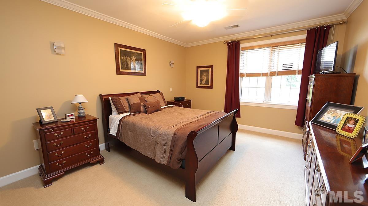 100 Northbrook Drive, Unit 203 Raleigh, NC 27609 - Photo 20 of 39 a bedroom with bed window and television