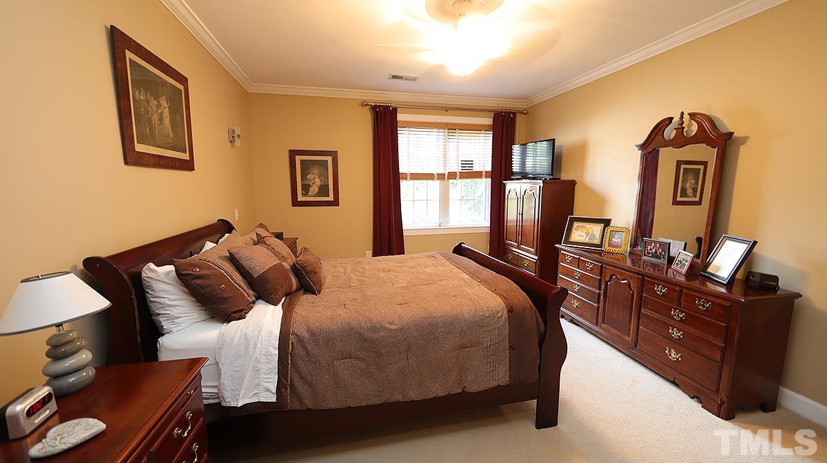 100 Northbrook Drive, Unit 203 Raleigh, NC 27609 - Photo 21 of 39 a bedroom with bed and window