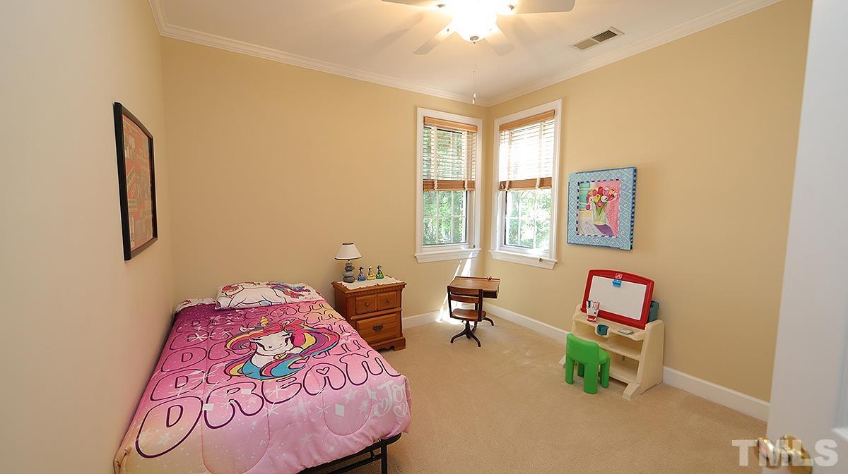 100 Northbrook Drive, Unit 203 Raleigh, NC 27609 - Photo 25 of 39 a bedroom with a bed and window