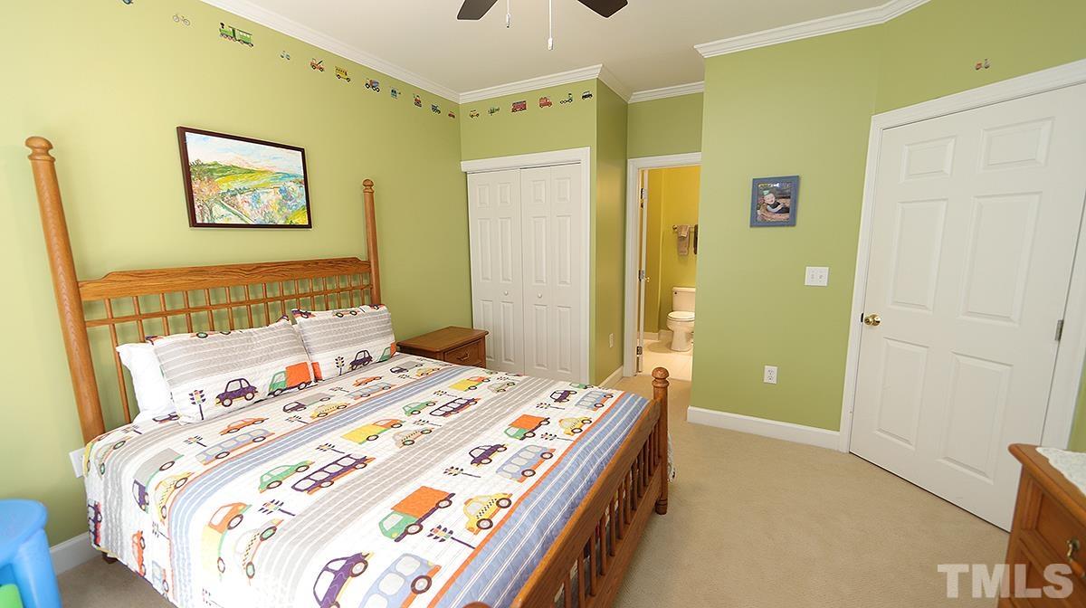 100 Northbrook Drive, Unit 203 Raleigh, NC 27609 - Photo 27 of 39 a bedroom with a bed and a dresser