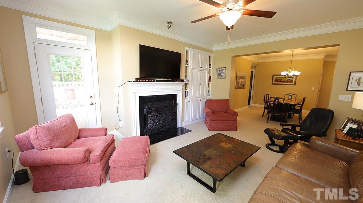 100 Northbrook Drive, Unit 203 Raleigh, NC 27609 - Photo 7 of 39 a living room with furniture a flat screen tv and a fireplace
